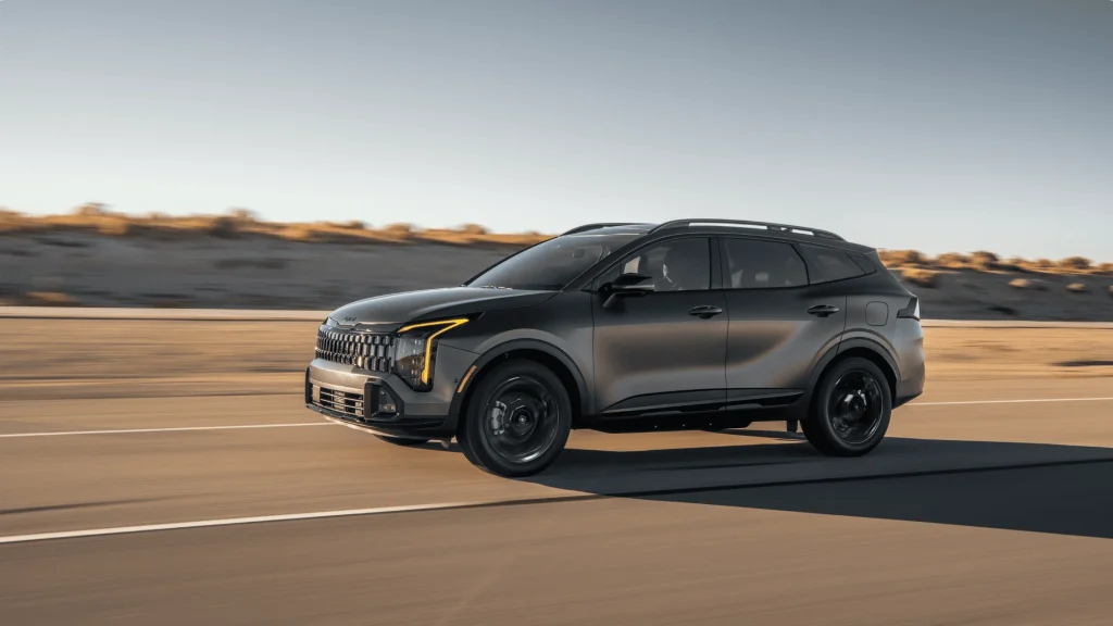 2026 Kia Sportage PHEV captured on desert highway highlighting sleek plug-in hybrid SUV look.