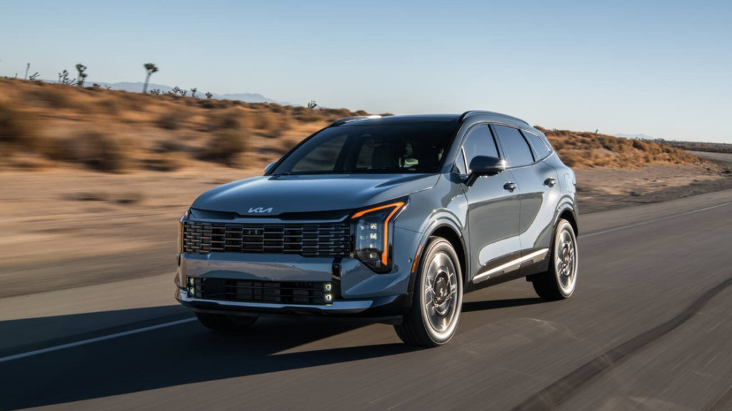 2026 Kia Sportage HEV hybrid SUV front three-quarter exterior view driving on a desert road.