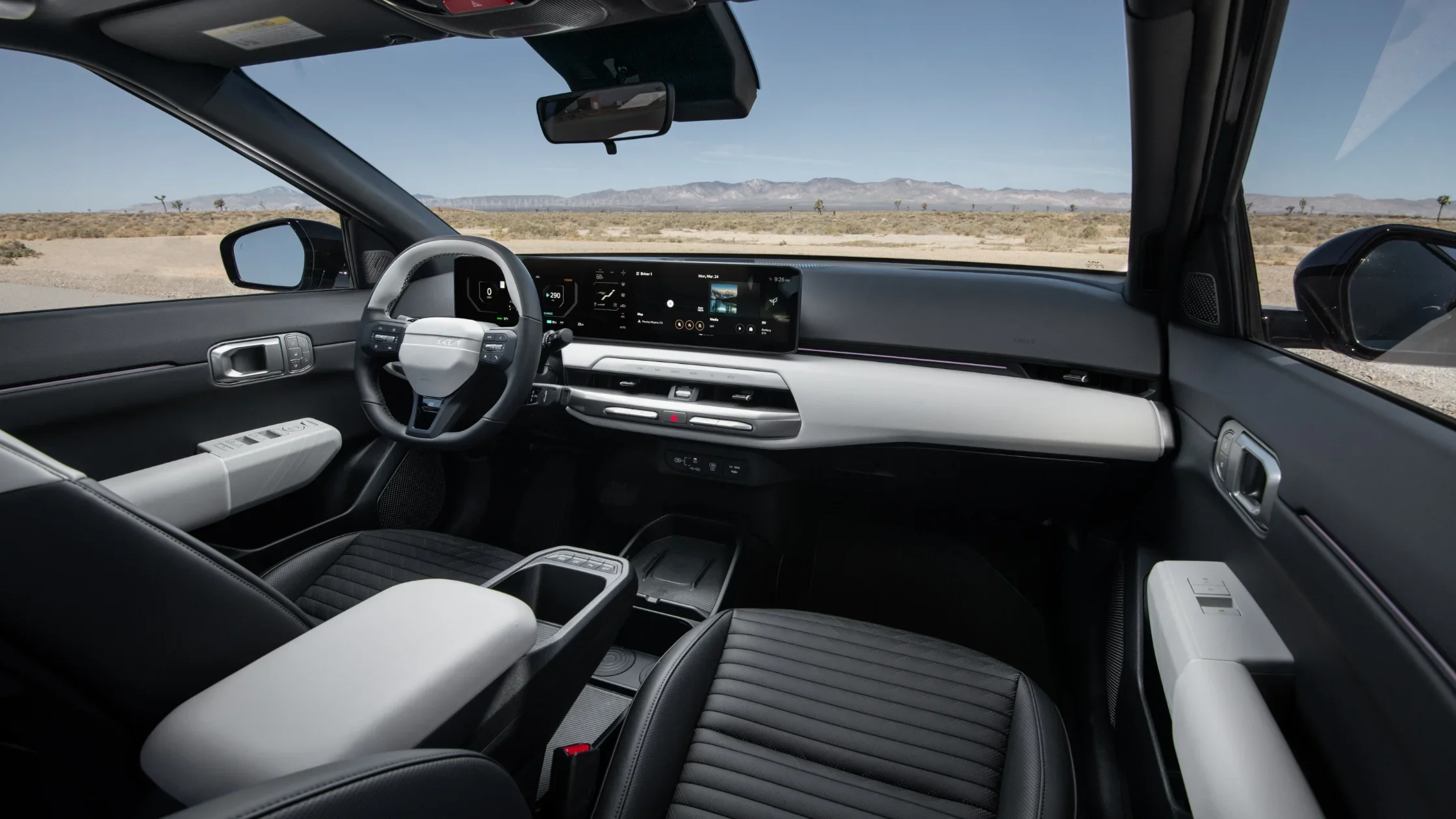 2026 Kia EV4 front interior with two-tone black and white cabin and digital display.