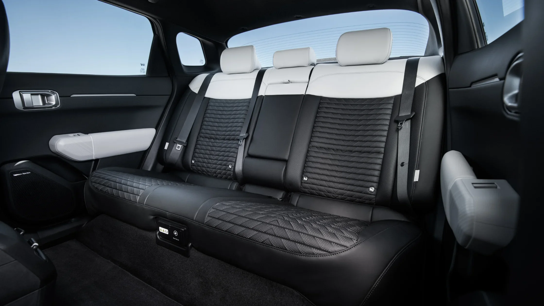 2026 Kia EV4 rear seats with quilted black leather and white headrests in modern design.