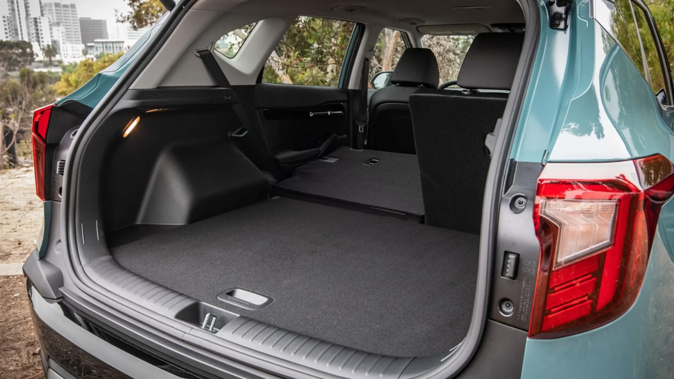 Cargo area of the 2026 Kia Seltos with rear seats folded flat, offering expanded storage space.