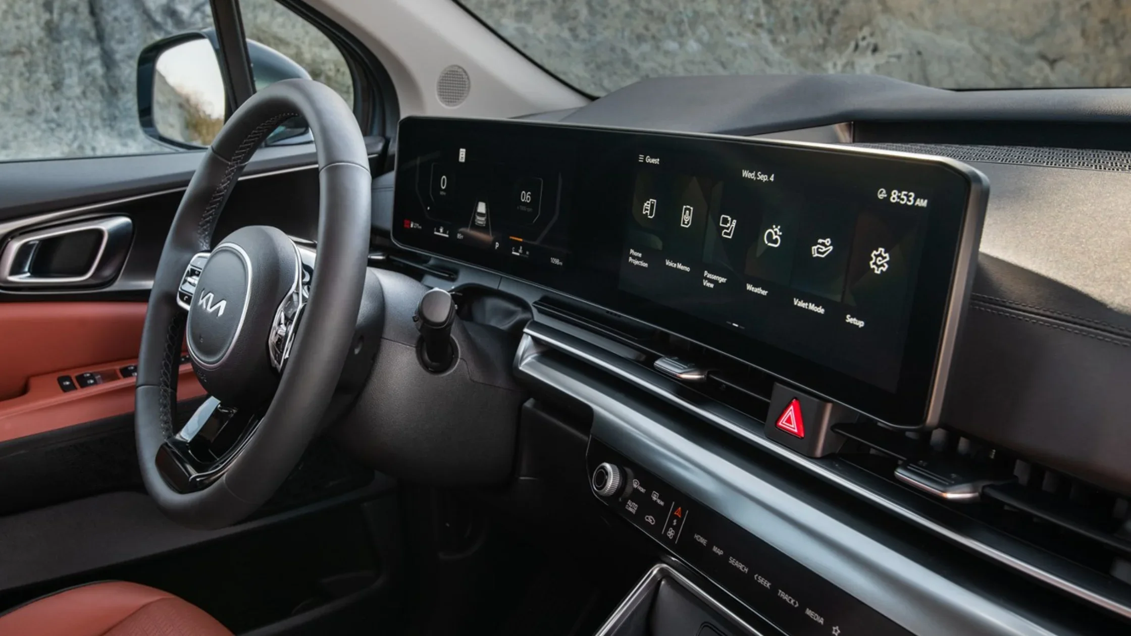 2026 Kia Carnival interior with digital display and leather steering wheel close-up view.