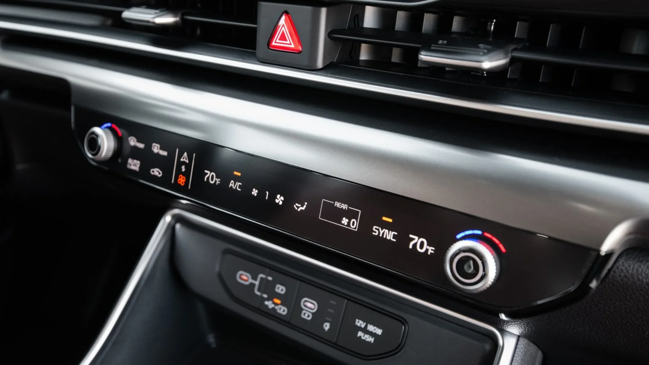 2026 Kia Carnival climate control panel with dual-zone temperature settings and console.