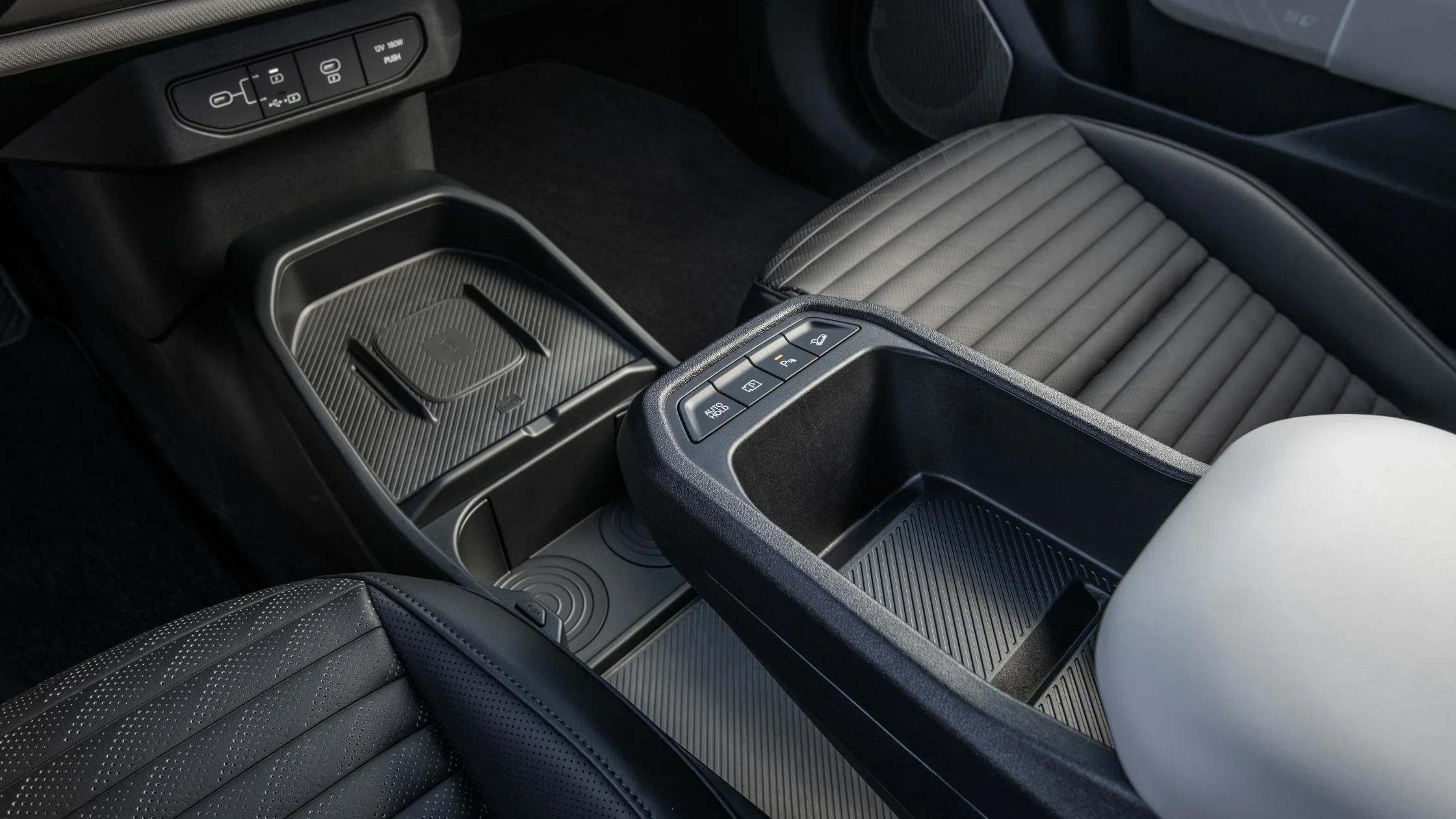 2026 Kia EV4 center console with gear shift, drive mode selector, and wireless charging pad.